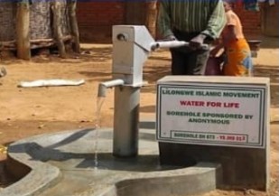 Hand pump borehole providing clean water in Malawi village